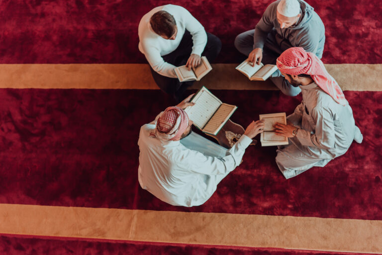 Students sitting together reading the Quran during a lesson